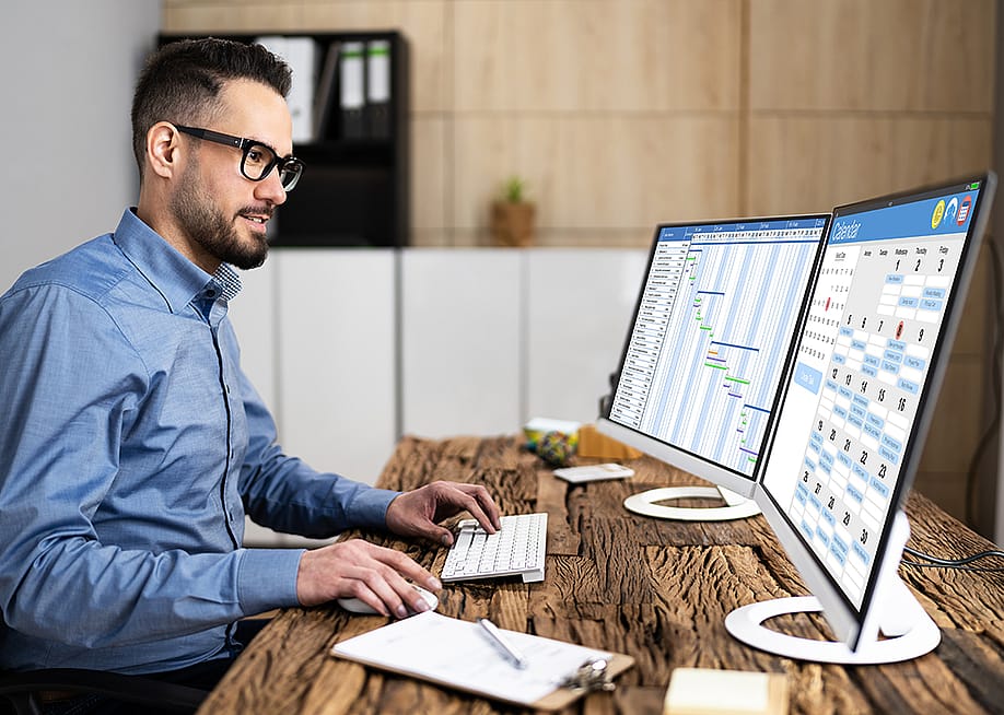 An employee working on calendar scheduling and staff time sheet. — Andrey_Popov // Shutterstock