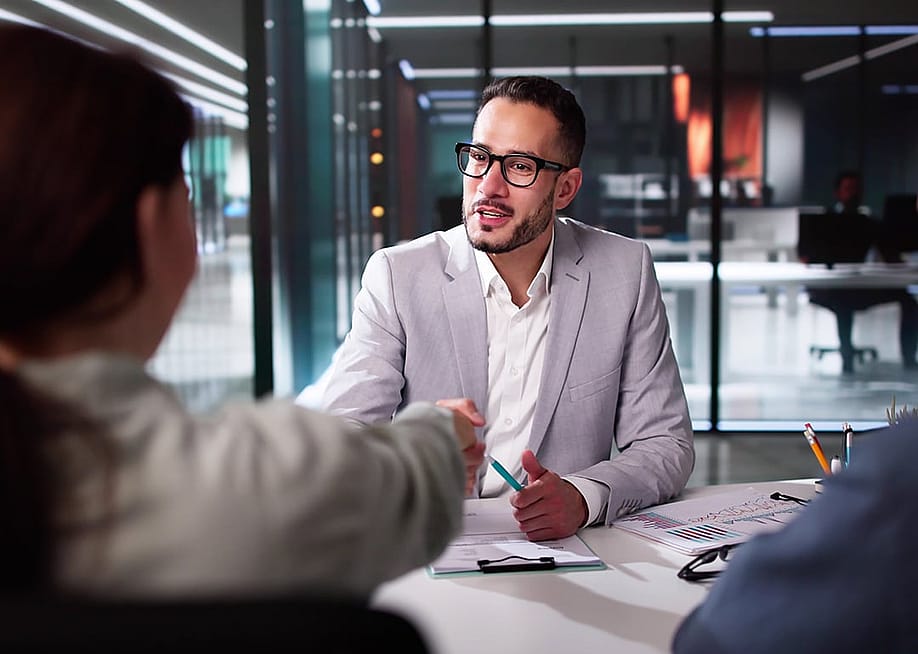 A tax advisor shaking hands with a client. — Andrey_Popov // Shutterstock