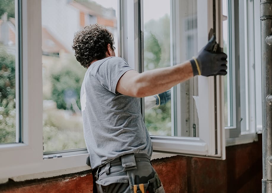 A window installer assembling a new unit of windows for a home. — NataKor // Shutterstock
