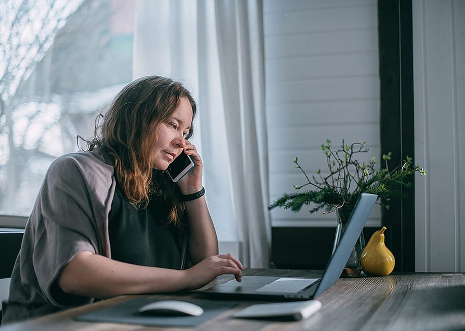 A person using a laptop and working from home. — Grusho Anna // Shutterstock