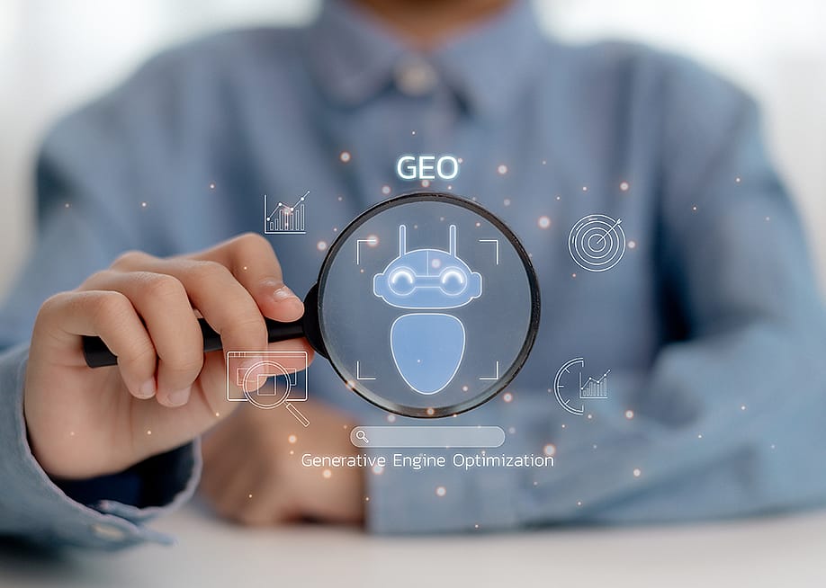 Person holding a magnifying glass illustrated with GEO concept graphics. — CL STOCK // Shutterstock