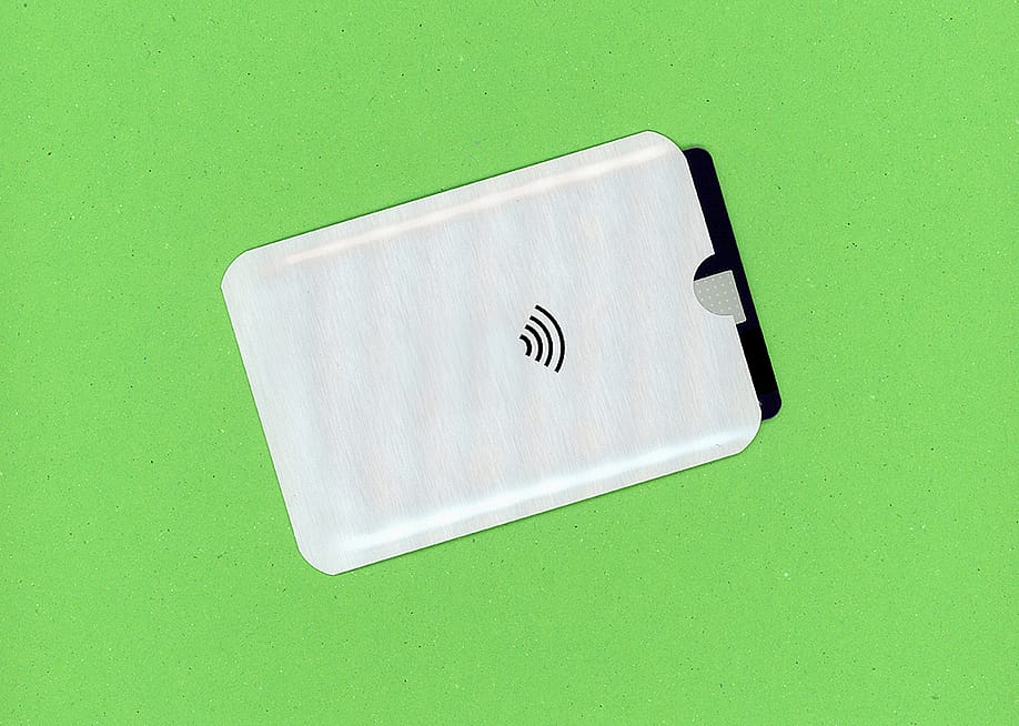 An RFID wallet against a green background. — Claudio Divizia // Shutterstock