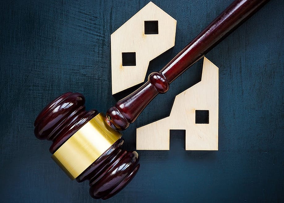 A wood house block separated by a gavel into two parts. — Vitalii Vodolazskyi // Shutterstock