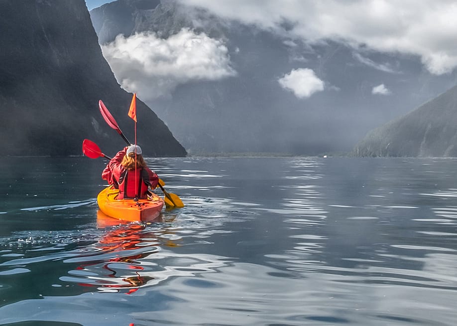 Kayakers on a lake. — Courtesy of EF Adventures