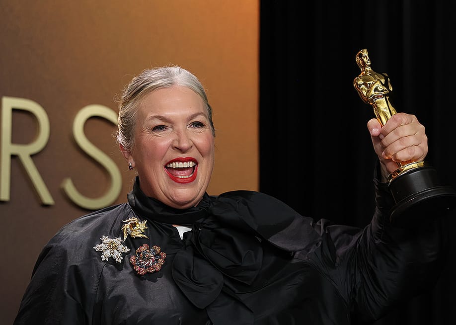 Kate Hawley holding up her Oscar trophy during the 98th Annual Academy Awards. — Kayla Bartkowski // Los Angeles Times via Getty Images