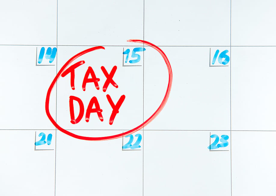 April 15th on a calendar encircled in red with a label 'Tax Day'. — xalien // Shutterstock