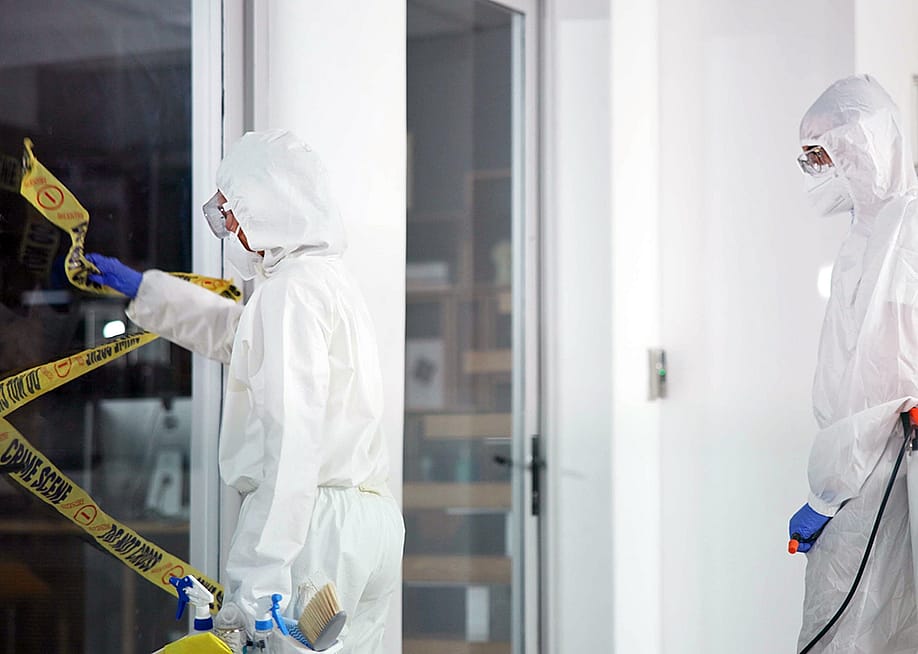 A forensic team removing a barrier tape from a crime scene. — PeopleImages // Shutterstock