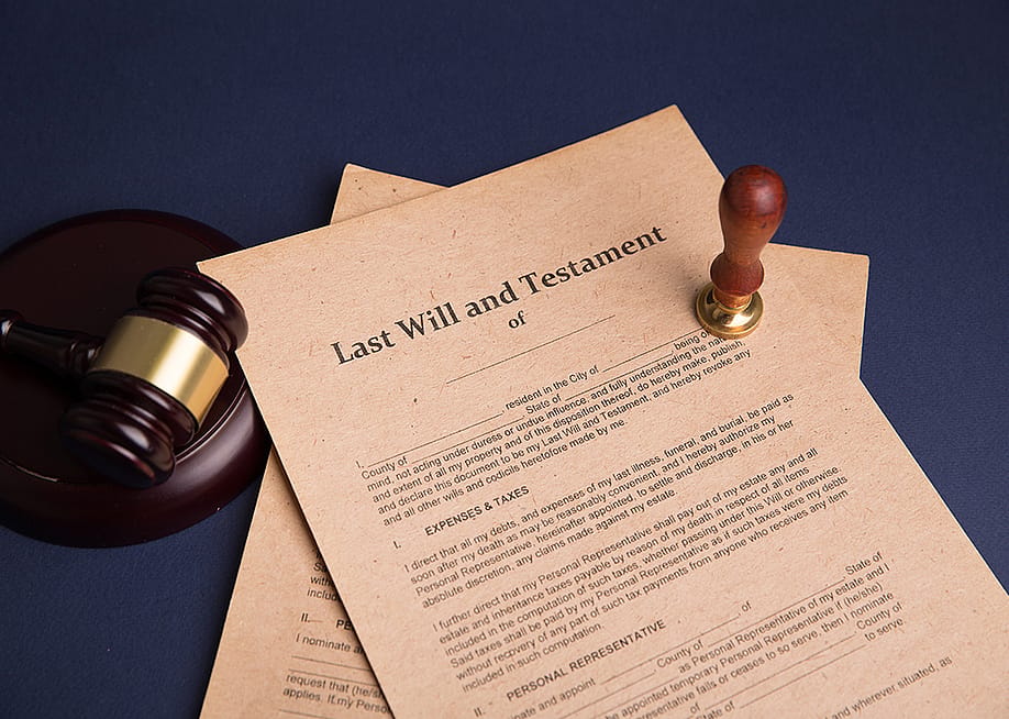 A notary's public pen and stamp on a last will and testament. — Burdun Iliya // Shutterstock