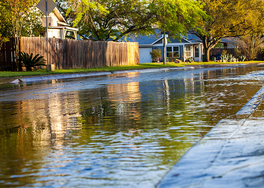 A shallow flood formed along a neighborhood after a thunderstorm. — Moab Republic // Shutterstock