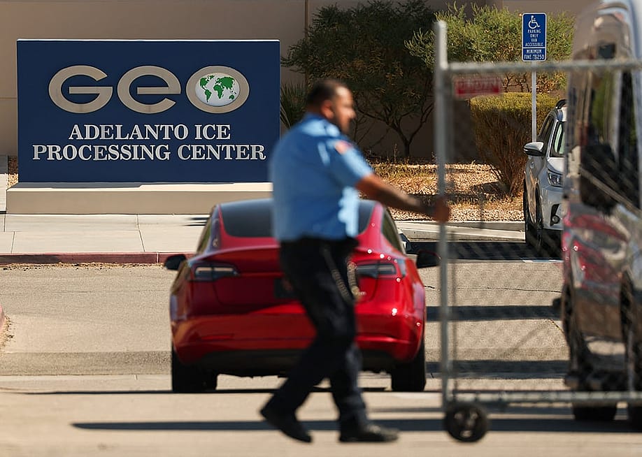 An officer closing a security gate at the GEO Group Adelanto ICE Processing Center in California. — Patrick T. Fallon // AFP via Getty Images