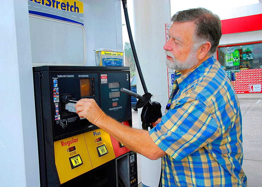 A man pays for gas at a station with credit card. — Dennis MacDonald // Shutterstock