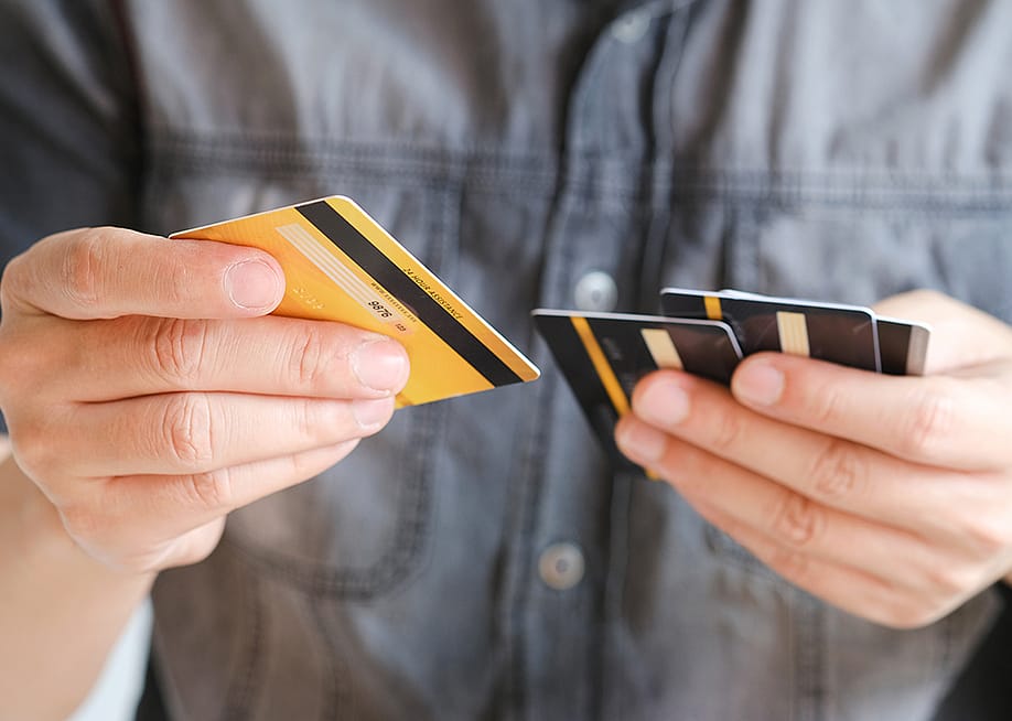 Man choosing from several credit cards. — Me dia // Shutterstock