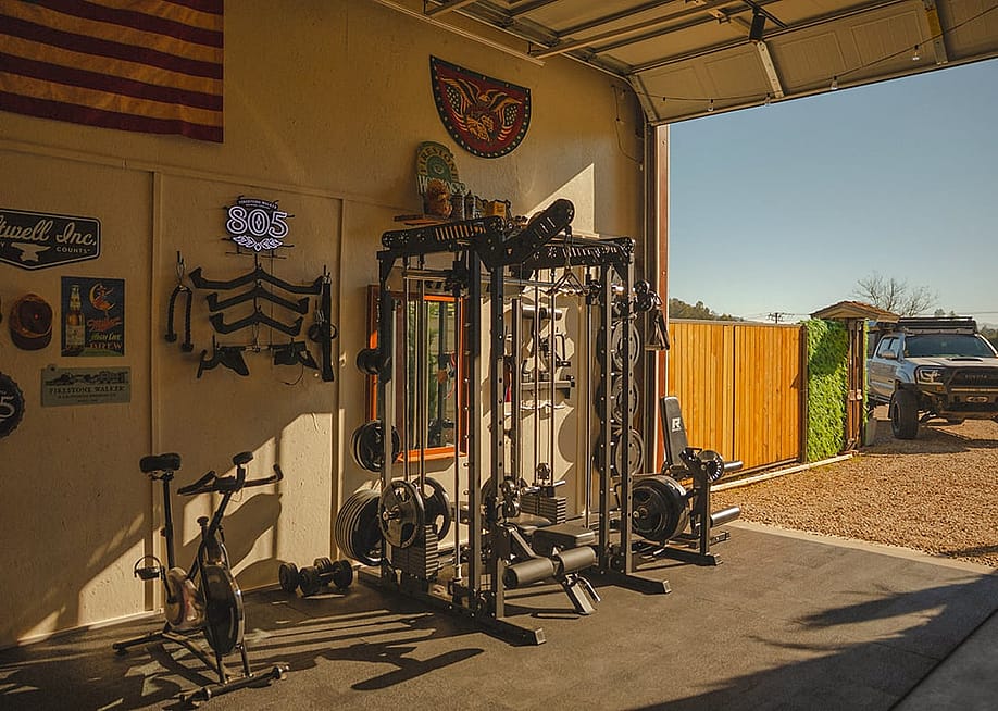 Gym equipment set up in a home's garage. — RITFIT
