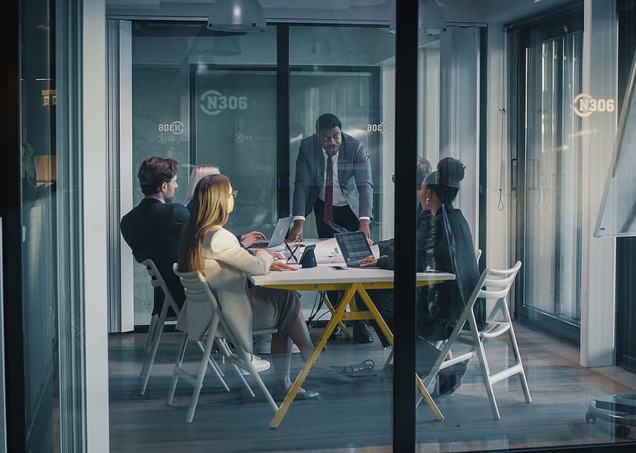 A focused team manager leading a meeting in a conference room. — Gorodenkoff // Shutterstock