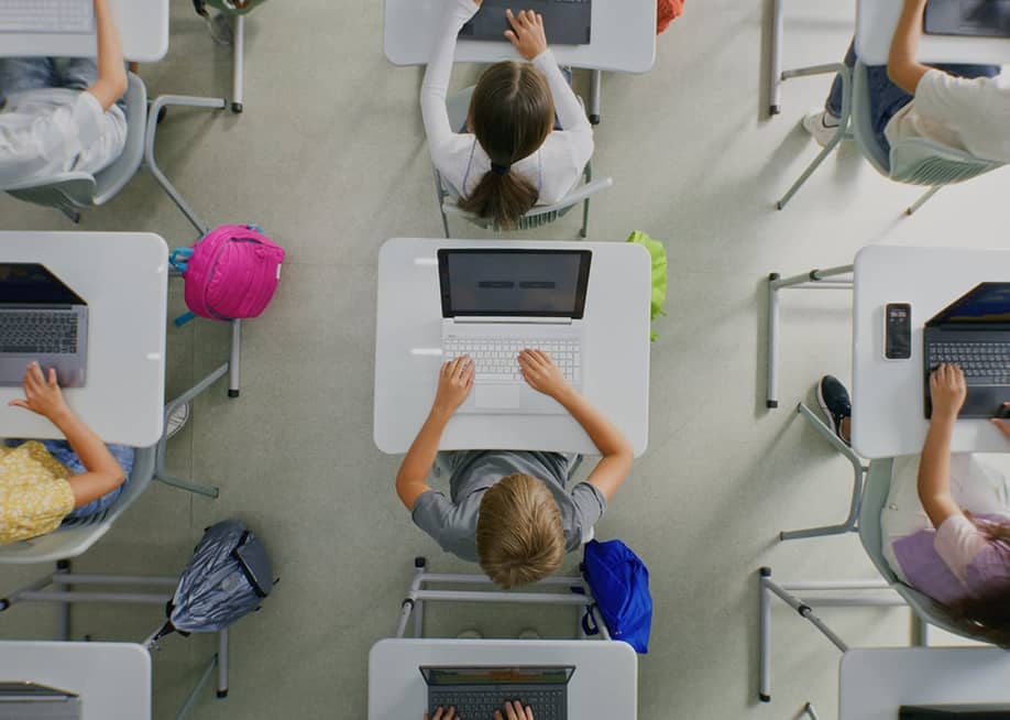 Ceiling view of students working on projects on their laptops inside the classroom. — Frame Stock Footage // Shutterstock