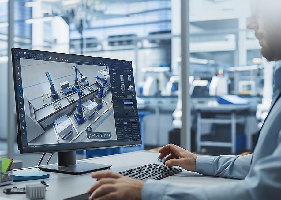 A factory engineer works with an advanced 3D CAD software to model robotic assembly line. — Gorodenkoff // Shutterstock