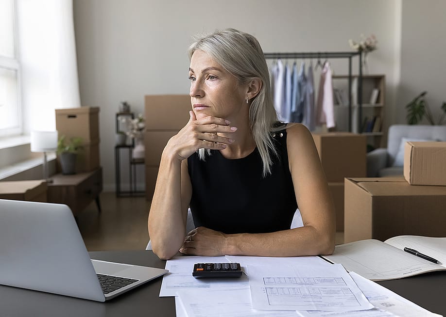 A business person thinking of finances at a home office. — fizkes // Shutterstock
