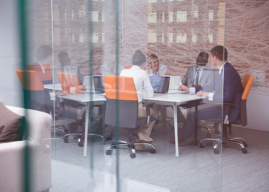 A group of business people during a meeting from a modern office. — dotshock // Shutterstock