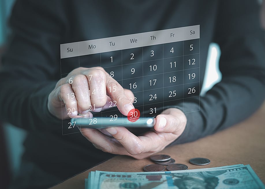 A person using a smartphone to check a virtual calendar. — Ben_24 // Shutterstock