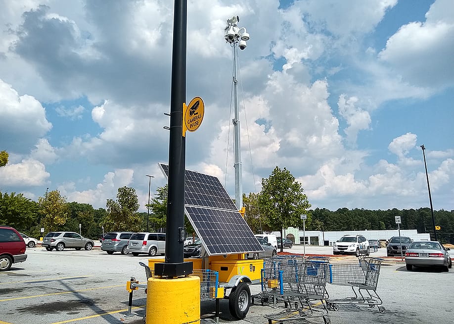 A solar powered surveillance system in a shop's parking lot in Atlanta, Georgia. — Jaimieandkyleshootstock // Shutterstock