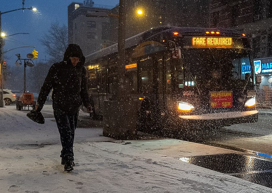 A person walks along the snowy street in New York City, USA. — David Dee Delgado // Getty Images