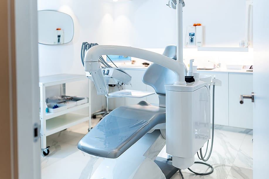 An empty dental patient's chair in a modern dental clinic. — Unai Huizi Photography // Shutterstock