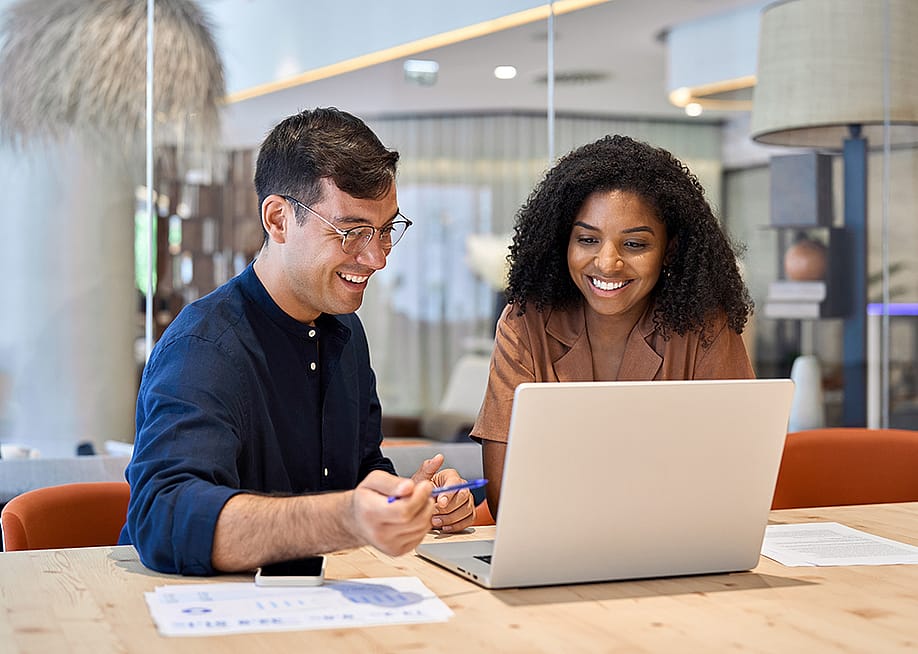 Coworkers working together on a task in an office. — insta_photos // Shutterstock