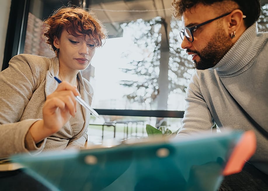 A diverse business team engaged in a discussion. — Gorgev // Shutterstock