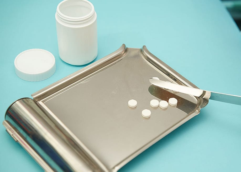 Pills on a tray for a medical prescription. — Vach cameraman // Shutterstock