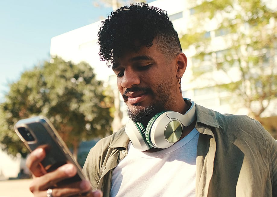 A young man checking phone outdoors. — Andrii Nekrasov // Shutterstock