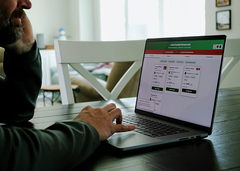 Man at home trying to buy a sports tournament ticket online. — Matt Fowler KC // Shutterstock