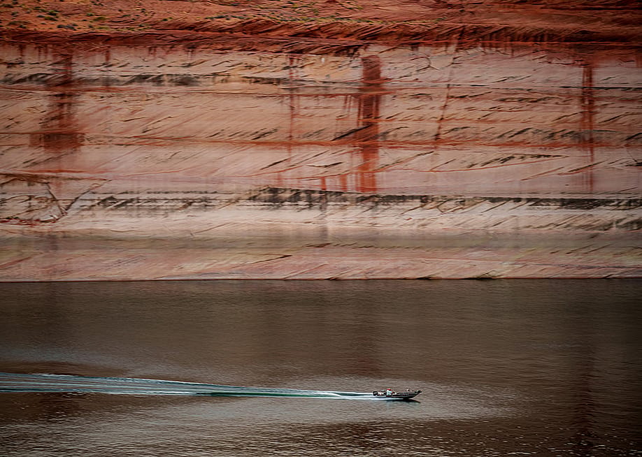 A powerboat cuts through the water on Lake Powell near Glen Canyon Dam in Page, Arizona. — Trent Nelson // The Salt Lake Tribune