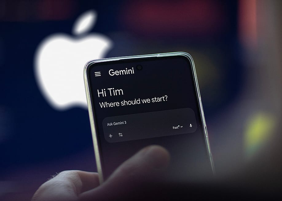 The Gemini app on a phone, with a blurred logo of Apple in the background. — Norbert Maurice // Shutterstock