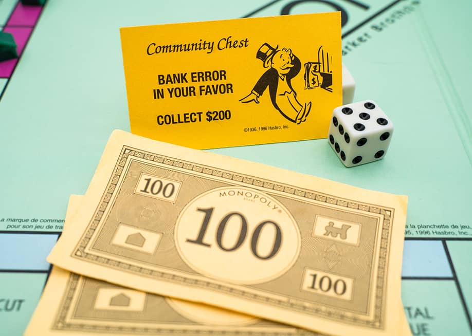 Banknotes and a bank error card from the Monopoly board game. — M.Pakats // Shutterstock