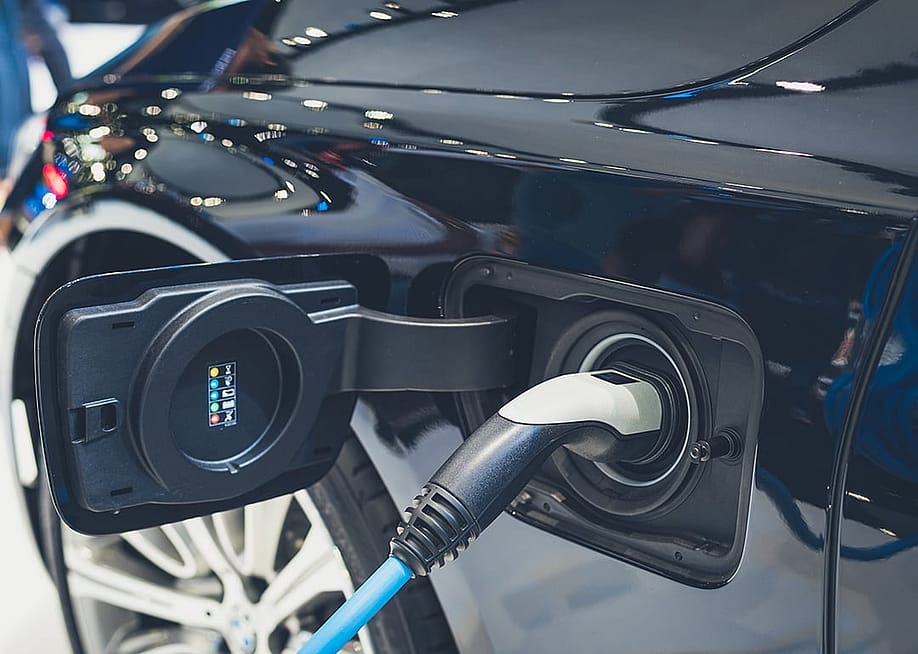 Close up on the charging socket of an EV. — Noppadol Kostsu // Shutterstock