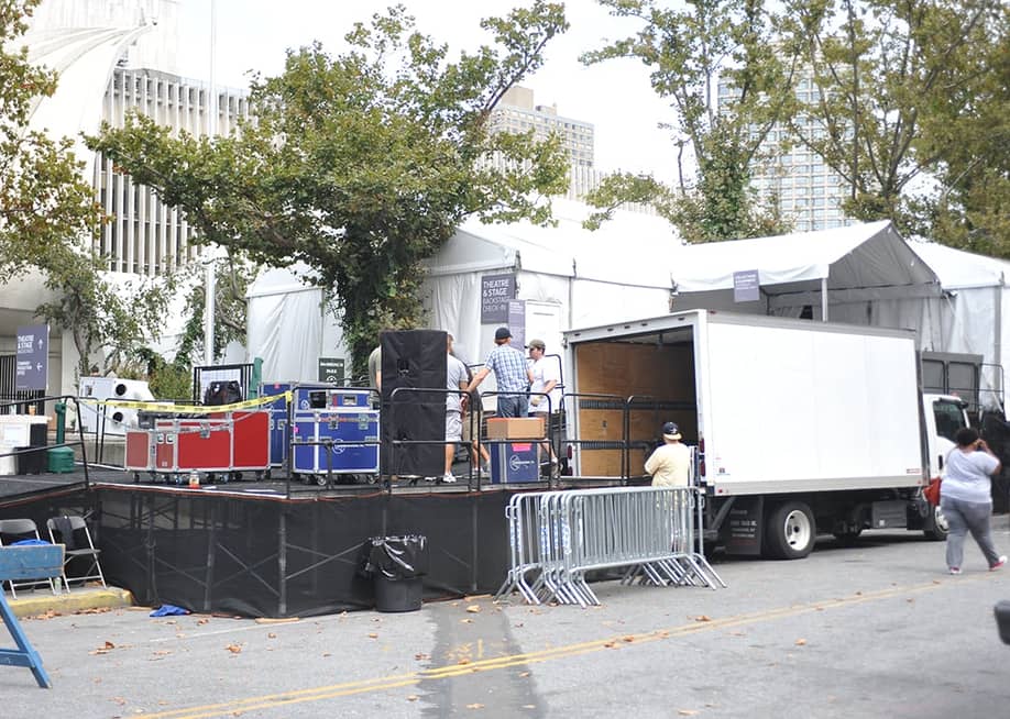 Workers build a backstage entrance at tents during a New York Fashion Week event. — FashionStock.com // Shutterstock