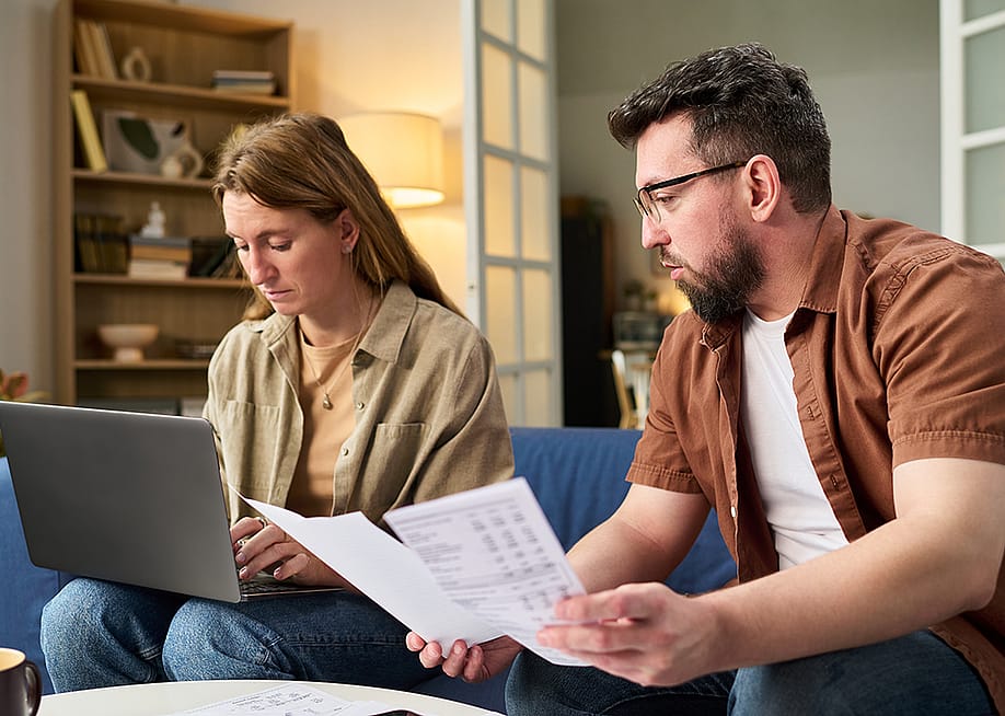Couple at home organizing tax documents. — Pressmaster // Shutterstock