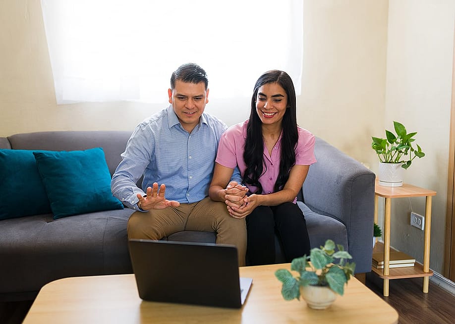 A couple at home attending a virtual therapy session. — antoniodiaz // Shutterstock