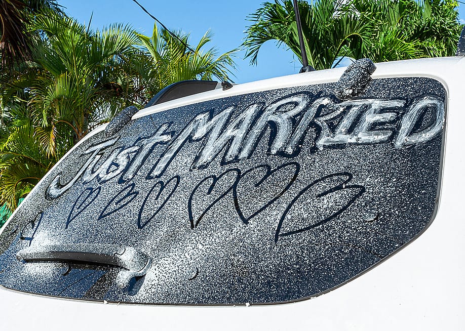 'Just married' written on a car window. — RandomHartz // Shutterstock