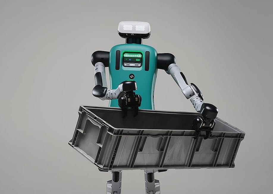 Digit the robot carrying a black crate. — Agility Robotics