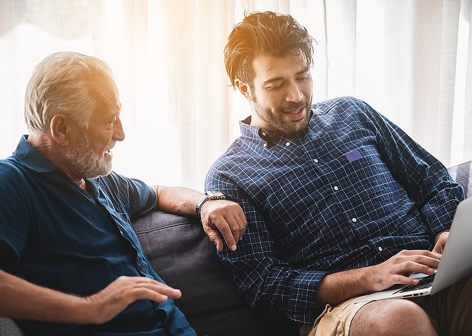 A senior father with his adult son discussing matters at home. — Chokniti-Studio // Shutterstock