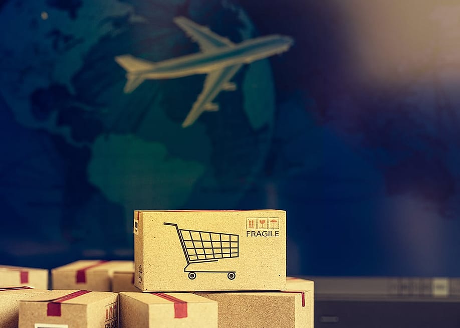 Fragile boxes with a background of air cargo as a concept of international shipping. — small smiles // Shutterstock