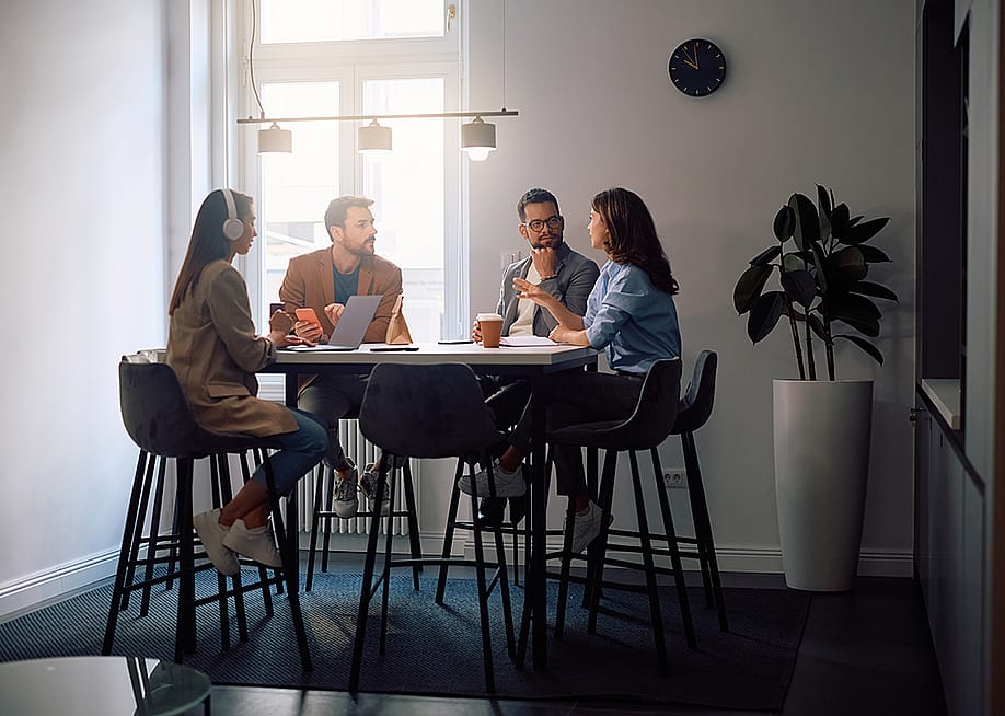 Colleagues talking about marketing strategies at the office. — Drazen Zigic // Shutterstock