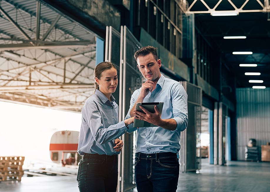 Warehouse managers checking logistic systems at work. — kelvn // Shutterstock