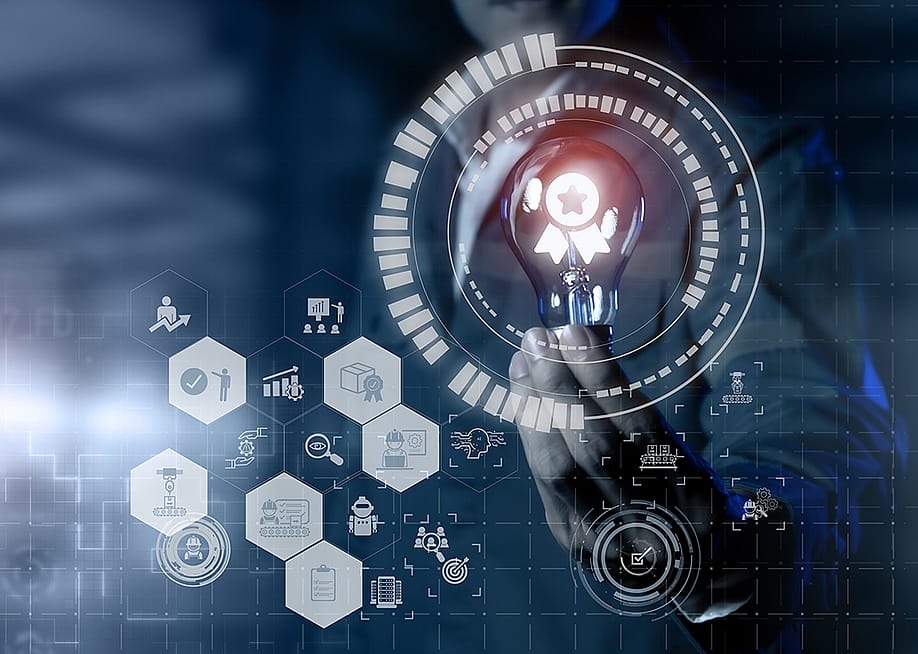 Concept of AI and quality management software graphics around a person holding a lightbulb. — MangKangMangMee // Shutterstock