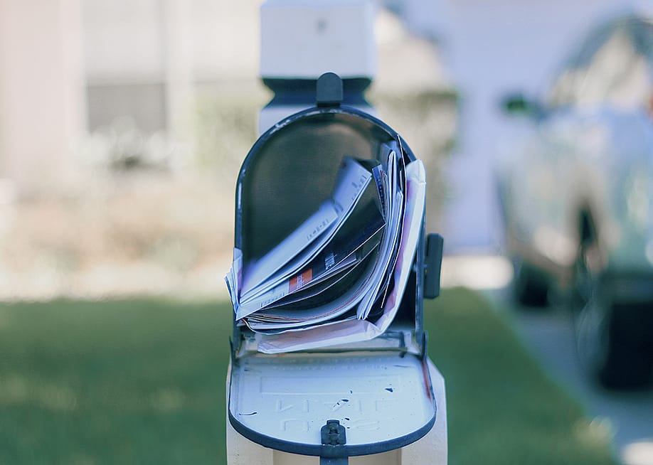 An opened mail box full of letters. — Wendy Routman // Shutterstock