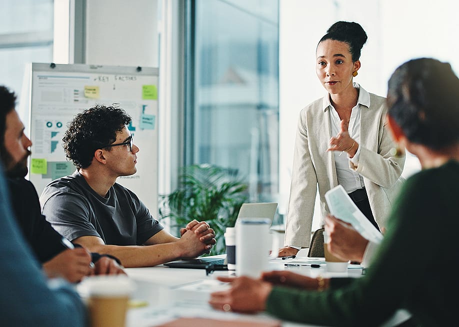 A businesswoman leading a marketing team's meeting. — PeopleImages // Shutterstock