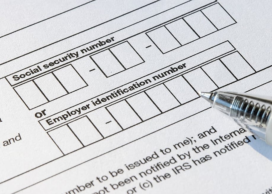 A close up on the the boxes for social security number (SSN) or employer identification number (EIN) on a W-9 form. — Tada Images // Shutterstock