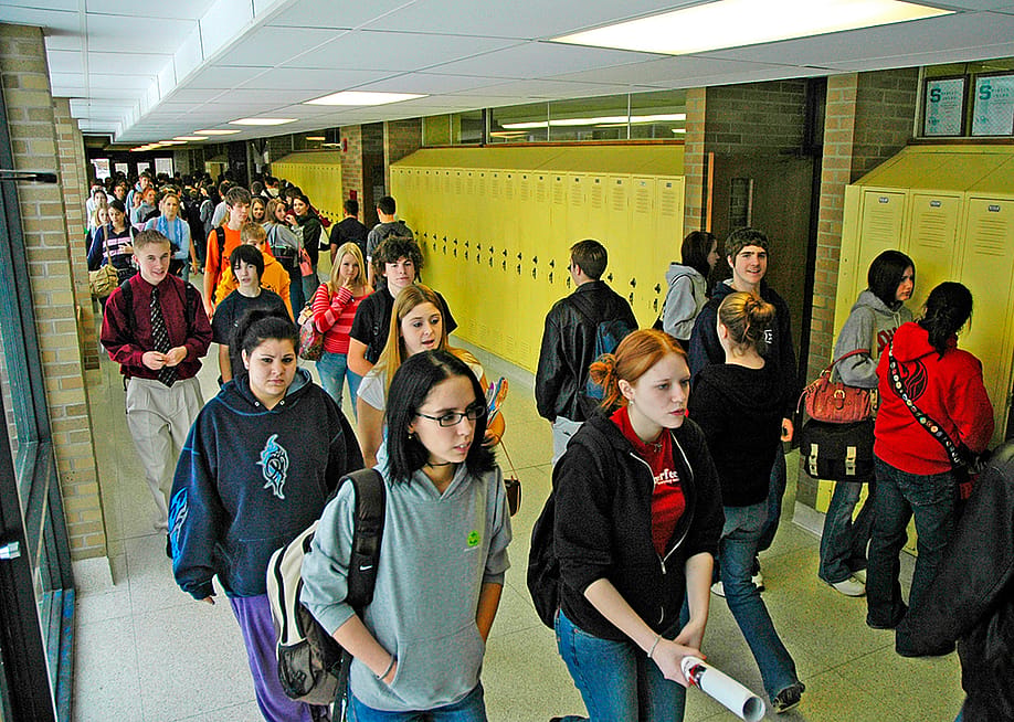 High school students walking along hallways. — Dennis MacDonald // Shutterstock