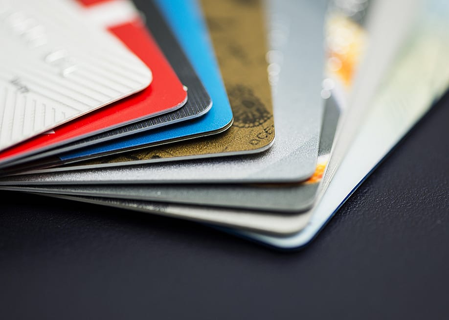 A stack of multicolored credit cards. — lentamart // Shutterstock